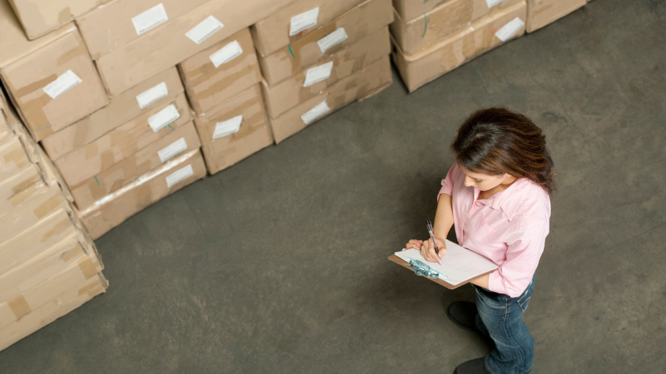 woman taking inventory at fulfillment center